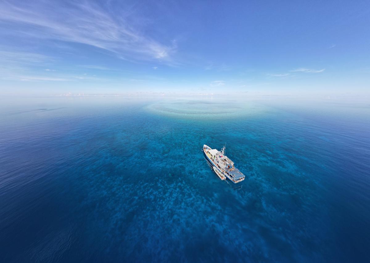 Drone photo of mv Resolute diving boat sailing across open sea, highlighting its full length and spacious decks