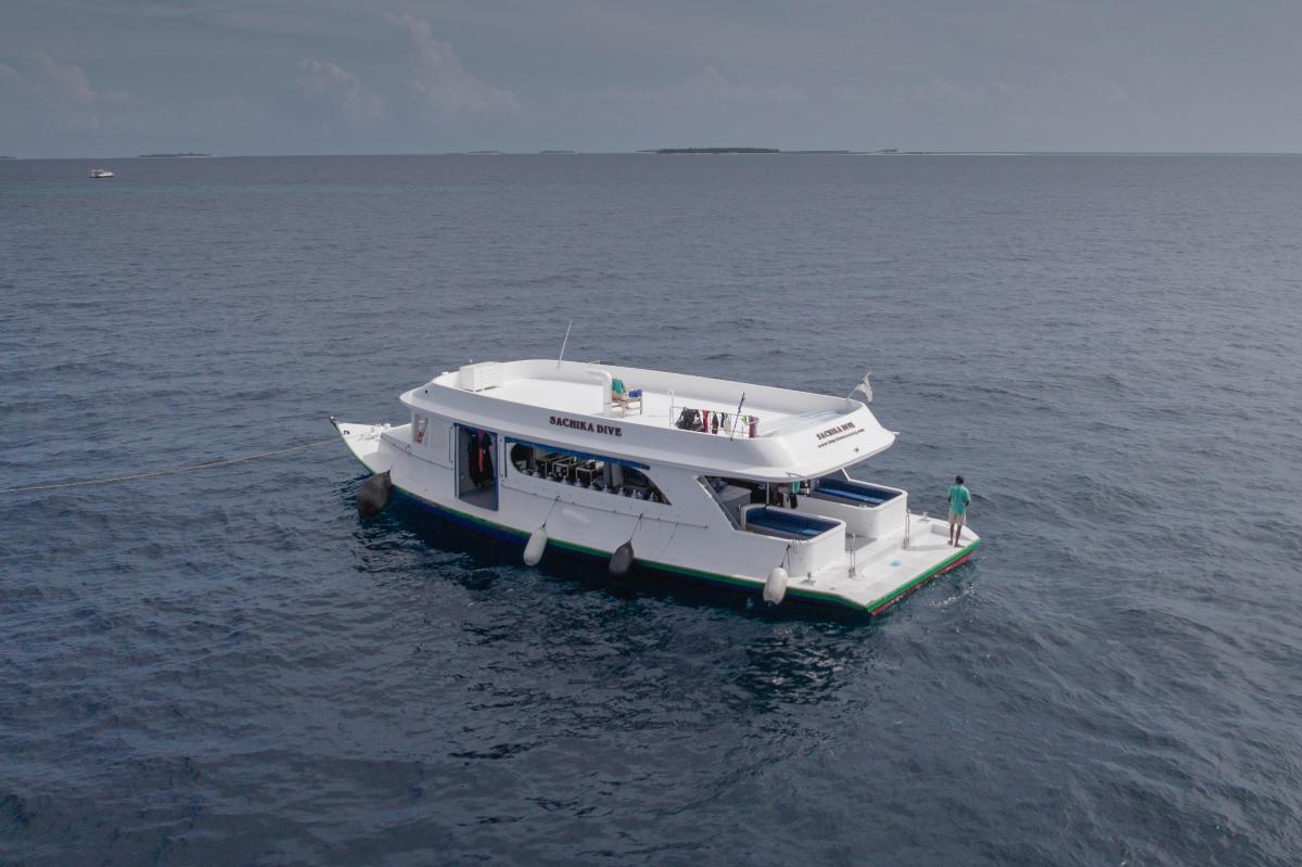 Dive dhoni beside sachika maldives liveaboard, prepared for diving operations.